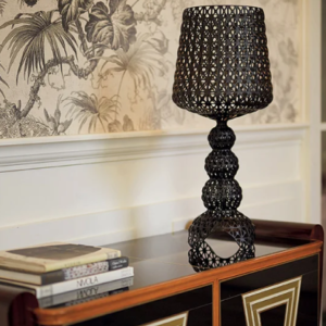 Small Mini Kabuki Table Lamp by Kartell in Black on a credenza cabinet