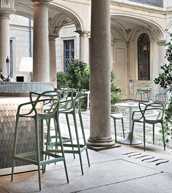 Kartell Masters Stools in Sage photographed at an outdoor bar restaurant